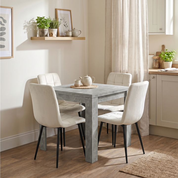[Concrete] Closed concrete-effect flip-top dining table with four cream chairs in a bright open-plan kitchen diner.