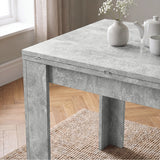 [Concrete] Close-up of the folded dining table concrete tabletop, steel hinges and wide supporting legs.