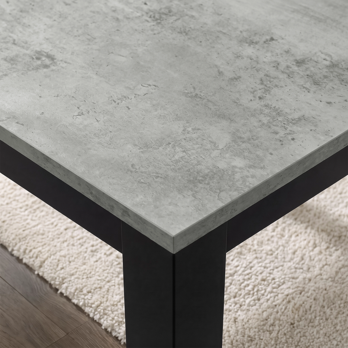 [140cm | Concrete] Close-up of stone-effect tabletop grain, beveled edge, square leg, and textured rug