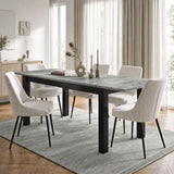 [140cm | Concrete] Extended table in bright dining room with six cream chairs, vases, candles, rug, and curtains
