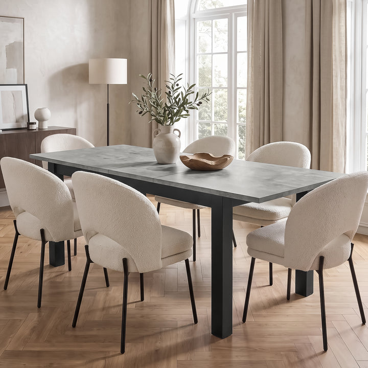[140cm | Concrete] 180cm extended table with six cream chairs, 40cm centre leaf, leafy vase, wooden bowl and black iron frame