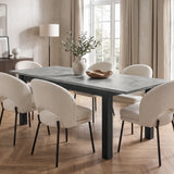 [160cm | Concrete] Extended 200cm dining table with six cream chairs, leafy vase and wooden bowl in a bright dining room.