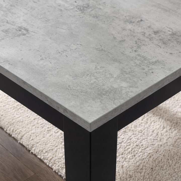 [160 cm | Concrete] Close-up of concrete-effect dining tabletop, layered grey edge, thick iron leg and matching black frame