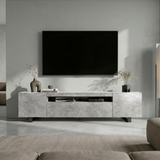 [Concrete] Kystra TV stand head-on under a large wall-mounted TV, two closed side cabinets flanking centre shelf