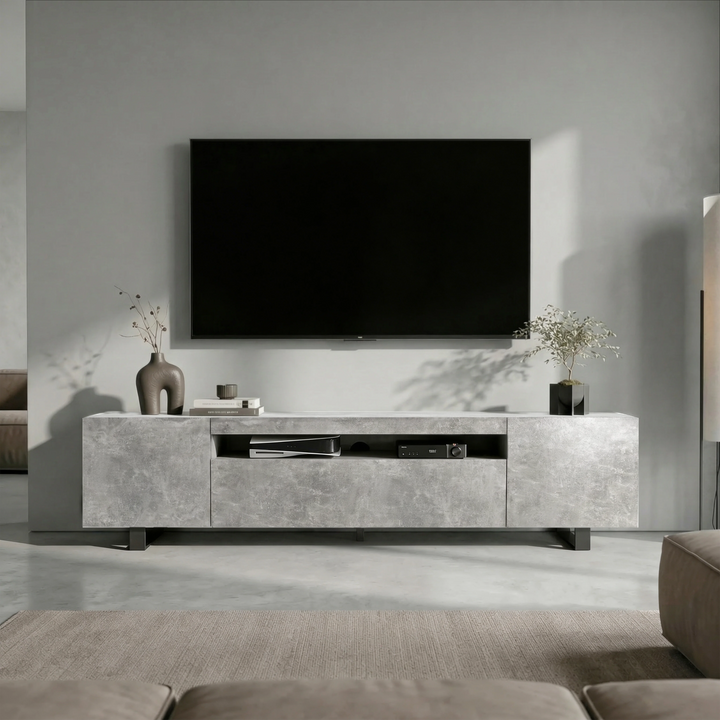 [Concrete] Kystra TV stand head-on under a large wall-mounted TV, two closed side cabinets flanking centre shelf