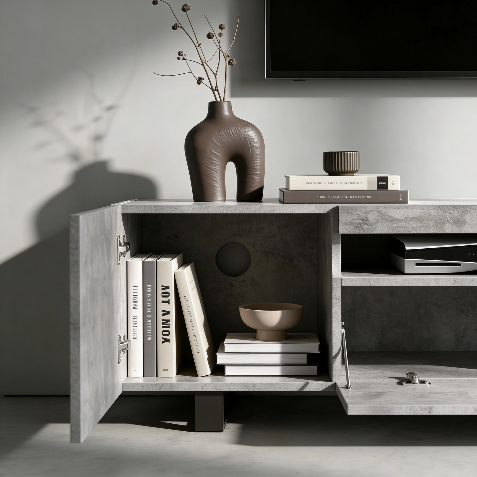 [Concrete] Kystra TV stand left compartment open, dark vase with stems on top and AV gear in centre