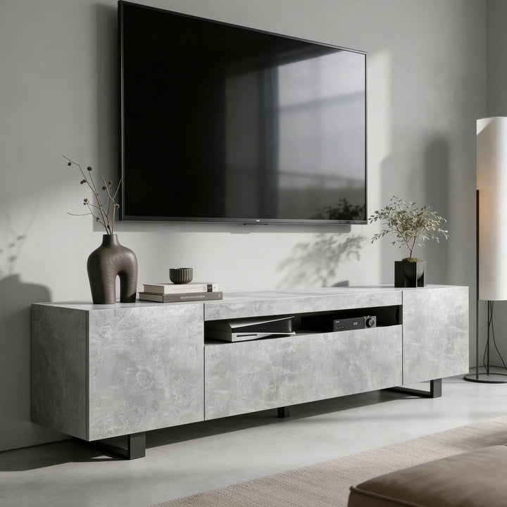 [Concrete] Kystra TV stand on grey wall under a wall-mounted TV, closed side cabinets and open centre shelf