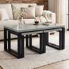 [Concrete] Nestline nesting table view showing in a bright lounge with cream sofa, brick wall, vase stems, and nested frames
