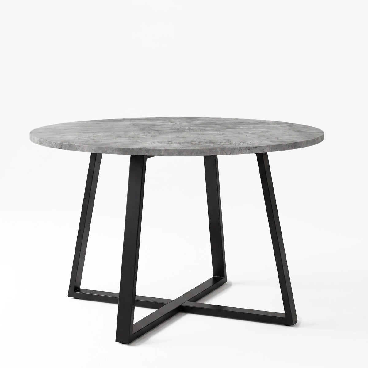 [Concrete] Round concrete-effect dining table in a studio view with the textured top resting on a black iron cross base.