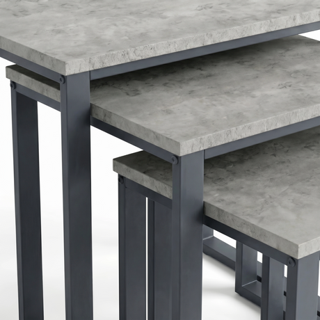 [Concrete] Stackora nest of tables close-up detail showing concrete-effect surface finish and dark grey metal corner bracket fixings on all three tops