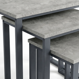 [Concrete] Stackora nest of tables close-up detail showing concrete-effect surface finish and dark grey metal corner bracket fixings on all three tops