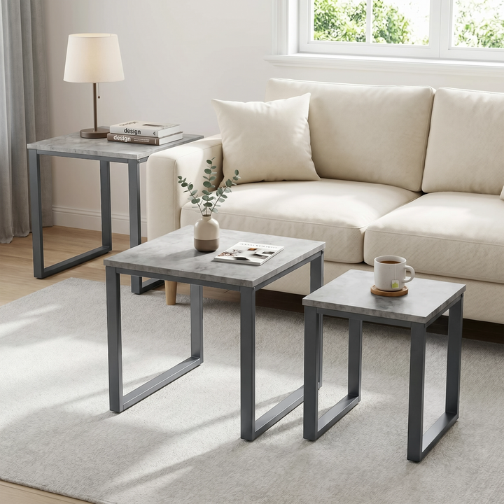 [Concrete] Stackora nest of tables set of 3 used separately across a bright living room as side table, coffee table, and accent table with lamp and plant