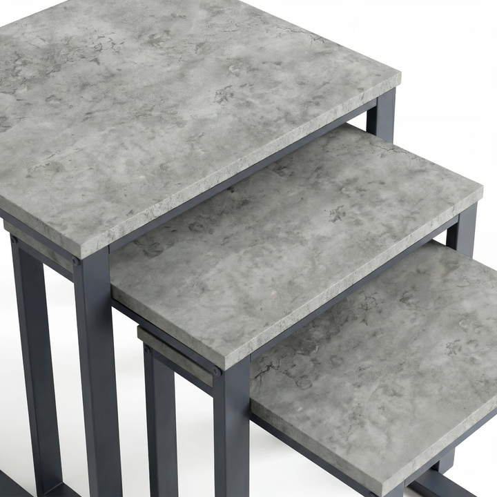 [Concrete] Stackora set of 3 nest of tables top-down close-up showing light grey concrete-effect texture and subtle veining across all three surfaces