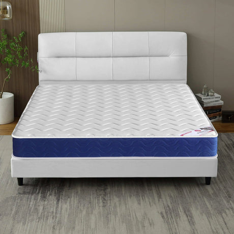 [White | Single] Sprung mattress on white tufted-panel headboard bed, black tapered legs, plant on the left.
