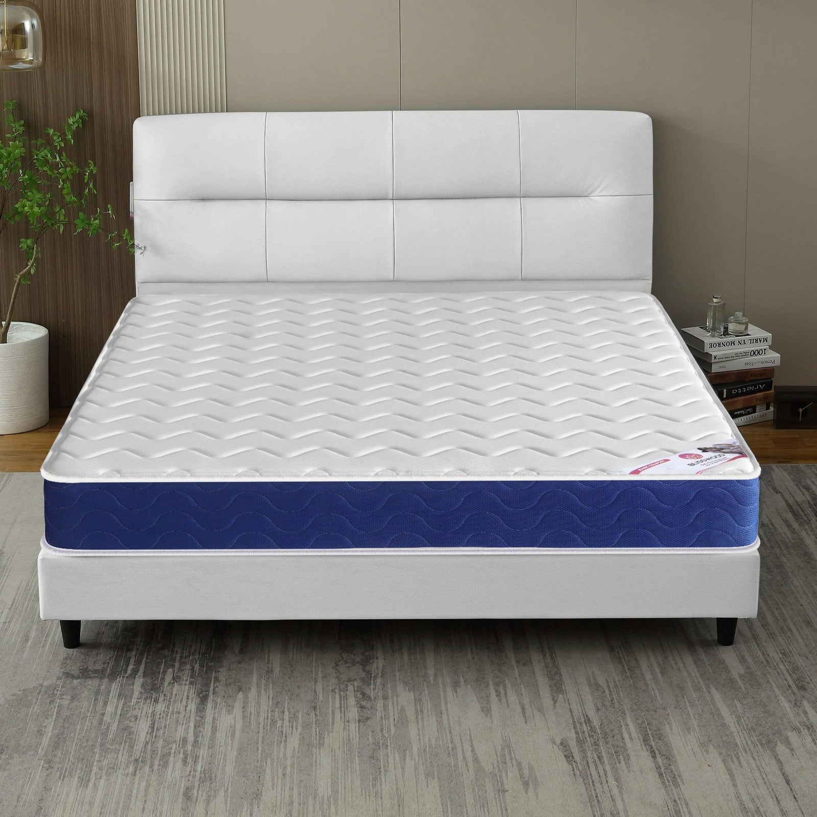 [White | Small Double] Sprung mattress room view, white panelled headboard, fabric divan base and corner wall lamp.