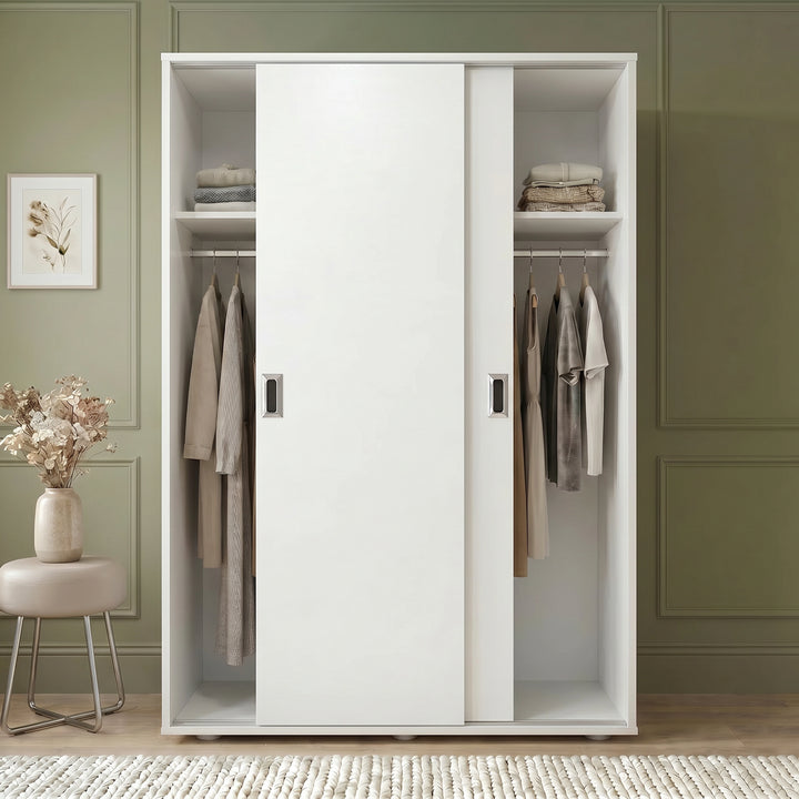 [Cool White]  White wardrobe with clothes in a room with green walls and a small table with flowers.