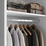 [Cool White] Torvek wardrobe interior close-up of chrome hanging rail with shirts and upper shelf with folded knits