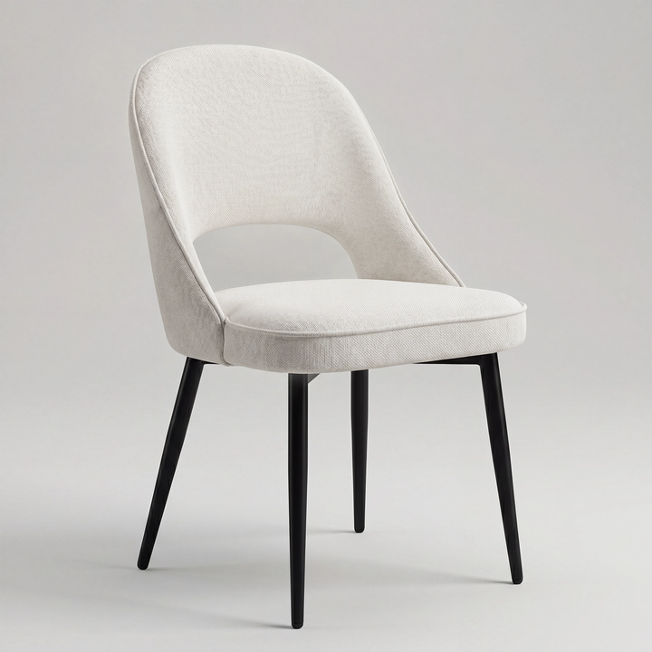 [Cream | Set of 2] Angled view of woven comfy dining chair with rounded open back, piped seat & four black metal legs.