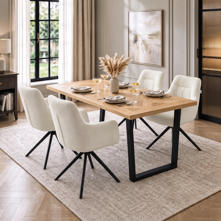 [Cream | Set of 4] Four swivel dining chairs with metal legs at a wood table set styled with plates, wine glasses and a vase.