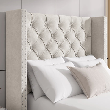 Close-up of beige velvet winged headboard with cross tufted pattern and studded trim, adding a touch of elegance.