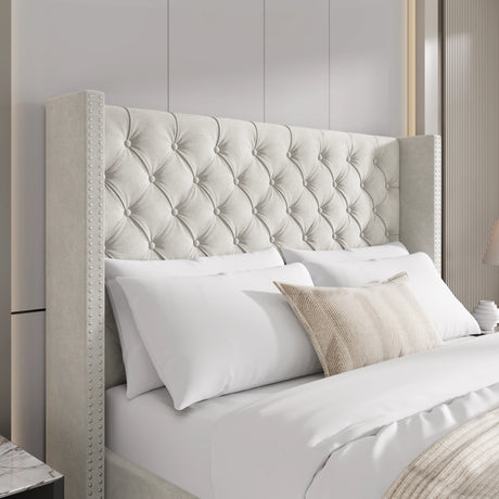 Close-up of beige small double velvet headboard with tufted cross pattern and studded winged design.