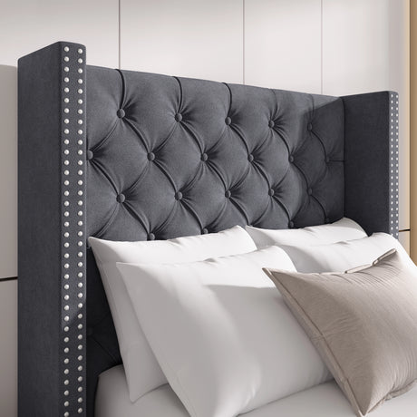Close-up of dark grey velvet winged headboard with tufted cross pattern and studded detailing for a luxurious look.