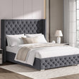 Small double dark grey velvet ottoman bed with cross pattern and winged headboard, styled with neutral bedding.