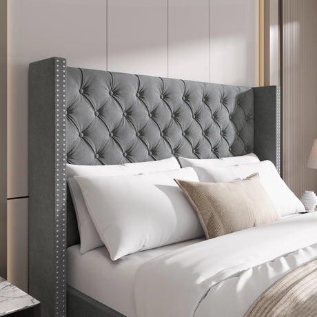 Close-up of mid-grey velvet headboard with cross tufting and studded winged sides for a refined bedroom look.
