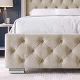 [Double | Beige] A close-up of a bed frame with a tufted cream upholstered footboard and matching headboard, styled with white bedding in a bedroom setting.