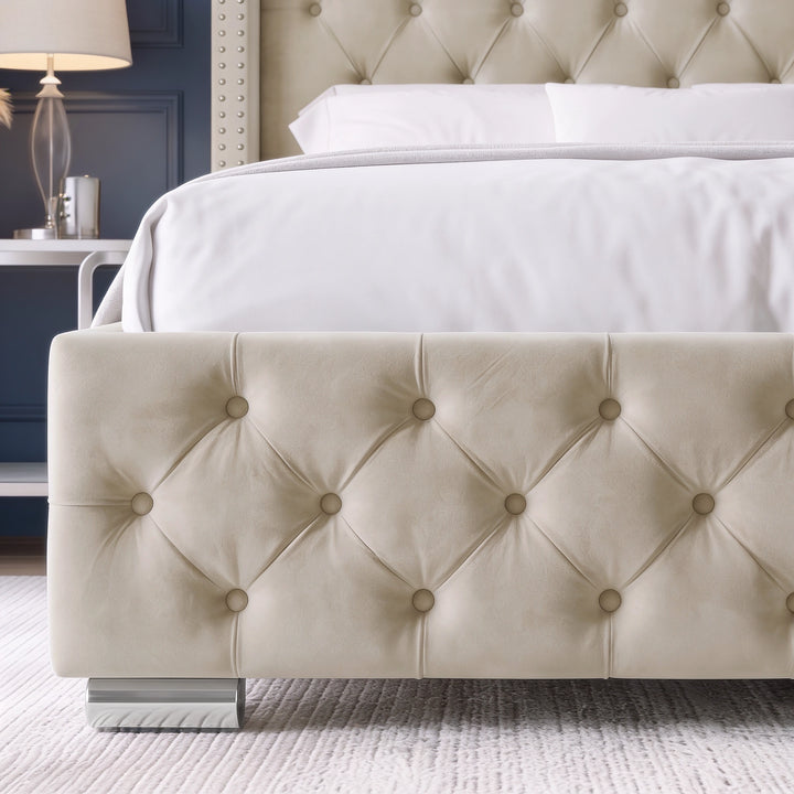 [Double | Beige] A close-up of a bed frame with a tufted cream upholstered footboard and matching headboard, styled with white bedding in a bedroom setting.