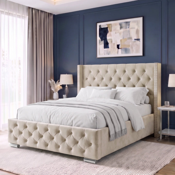 [Double | Beige] A modern upholstered bed with a tufted beige headboard and footboard, styled in a contemporary bedroom with a dark blue paneled wall, matching rug, and bedside tables.