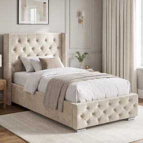 [Single | Beige] Cross ottoman bed side angle with winged tufted headboard and diamond-buttoned base in panelled bedroom