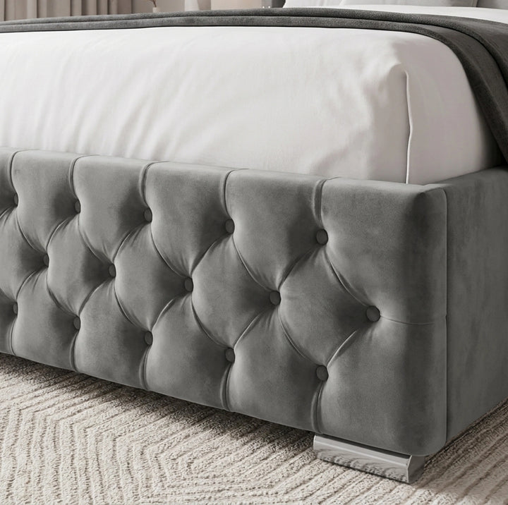 [King | Grey] gray tufted velvet bed frame with white bedding and a patterned rug.