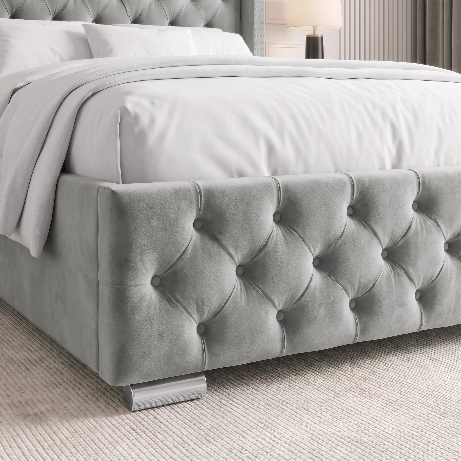 [Double | Light Grey] tufted velvet bed frame with white bedding, shown in a styled bedroom setting with a textured rug and a bedside lamp.