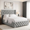 [Double | Light Grey] tufted velvet bed frame with a high wingback headboard and matching footboard, styled in a bright, contemporary bedroom with white bedding, wooden nightstands, and a large window.