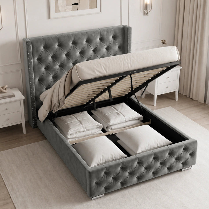 [Small Double | Grey] tufted velvet storage bed with the headboard and mattress lifted open to show the raised platform frame and bedding compartments, styled in a bright, modern bedroom.