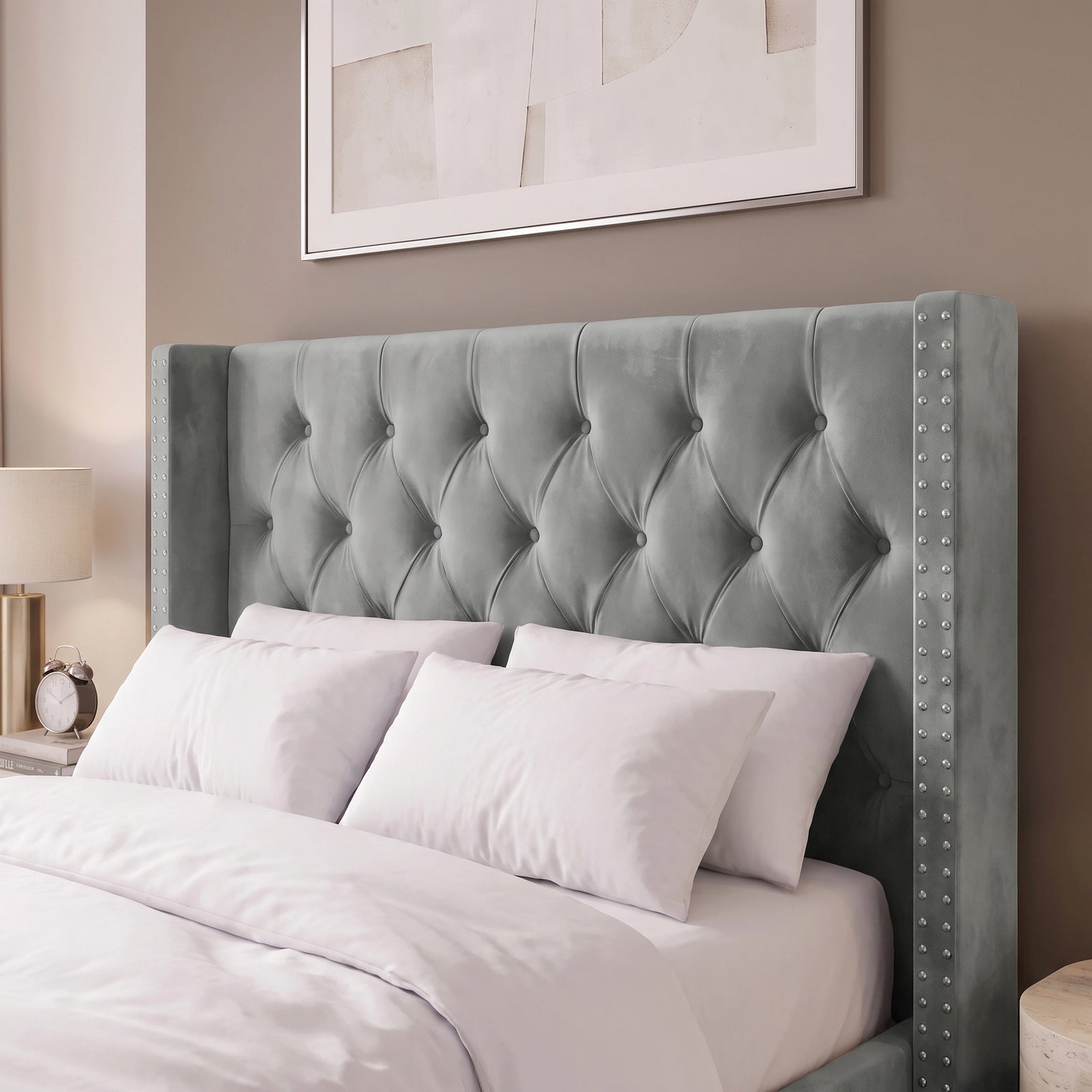 [Small Double | Light Grey] tufted velvet wingback headboard with nailhead trim on a bed with white bedding, set against a warm taupe wall with a framed print above.