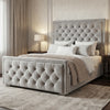 [King | Light Grey] Ottoman bed from the side with puffed diamond-tufted headboard in classic room with Persian rug