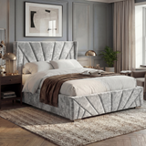 [King | Silver] Angled lifestyle of King silver crushed velvet ottoman bed with wing fan-pleated headboard