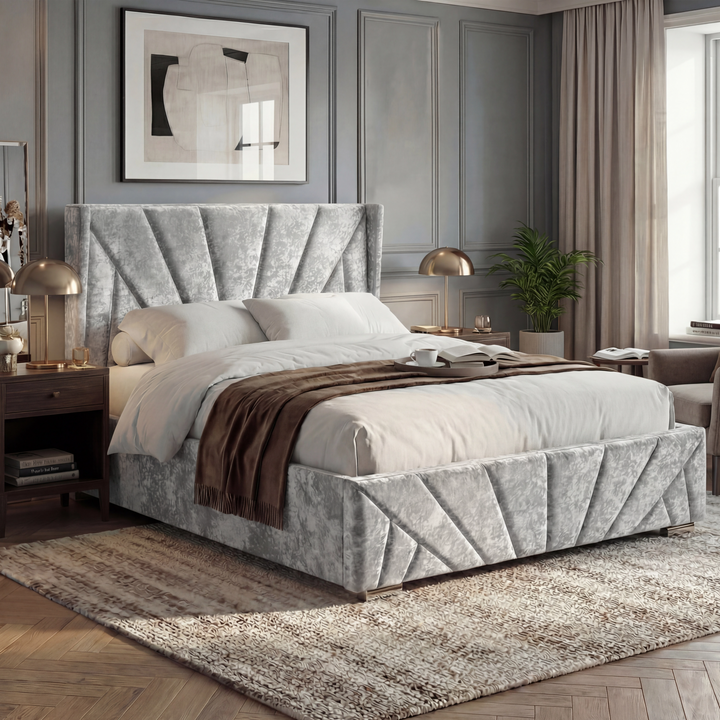 [King | Silver] Angled lifestyle of King silver crushed velvet ottoman bed with wing fan-pleated headboard