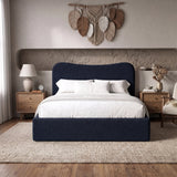 [Double | Blue] Front view of blue boucle double ottoman bed with curved headboard from front in natural day light.