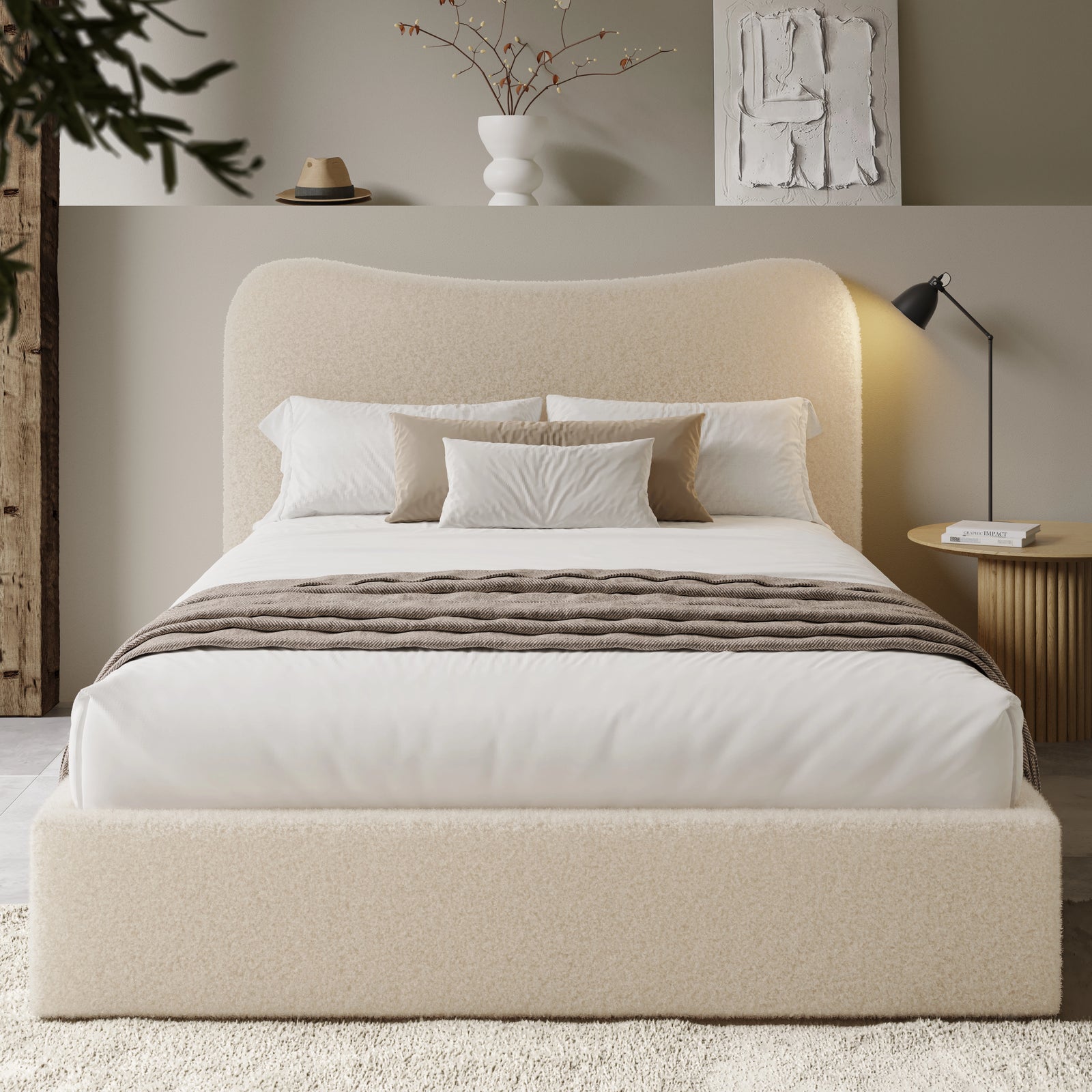 [Double | Beige] Front view of boucle ottoman bed with curved headboard in warm ambient evening lighting