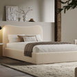 [King | Beige] Boucle fabric ottoman bed from the side with white bedding and fringed throw beside floating shelf with art