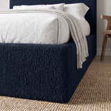 [King | Blue] Closer view of headboard curve and bedding arrangement with textured boucle fabric visible