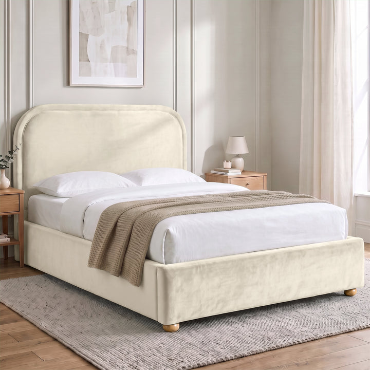 [Beige | Double] Curved headboard ottoman bed closed in bedroom, with plush beige upholstery and soft rounded edges