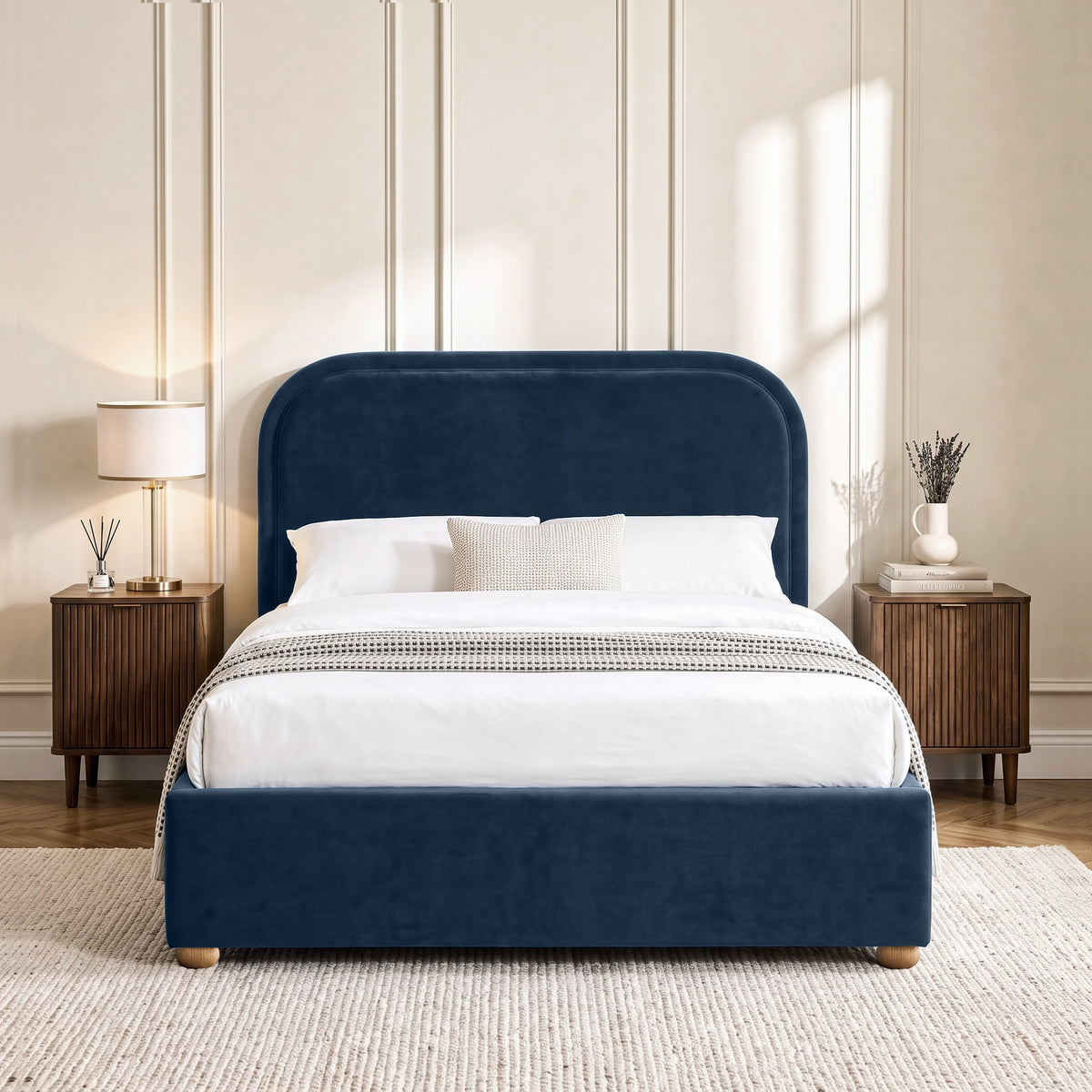 [Blue | Double] Curved headboard ottoman bed in blue plush velvet, front bedroom view with rounded wooden feet
