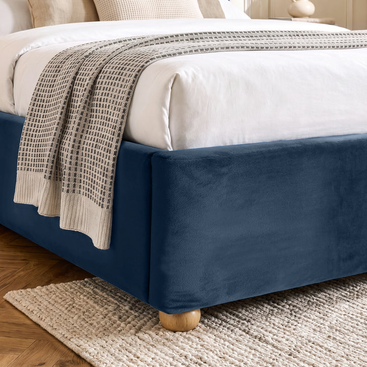 [Blue | Double] Close-up of plush upholstered base corner with rounded solid wood foot and soft curved edge