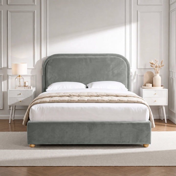 [Grey | Double] Curved headboard ottoman bed in grey plush velvet, front bedroom view with rounded wooden feet