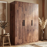 [Dark Bronx] wardrobe placed against a wall in a natural light room with glass planter beside it