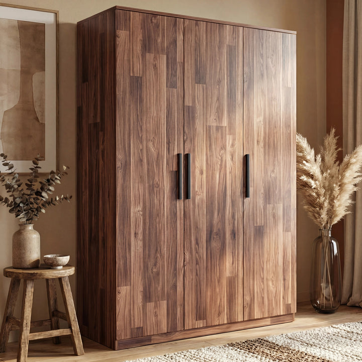 [Dark Bronx] wardrobe placed against a wall in a natural light room with glass planter beside it